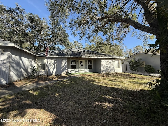 back of property with a lawn