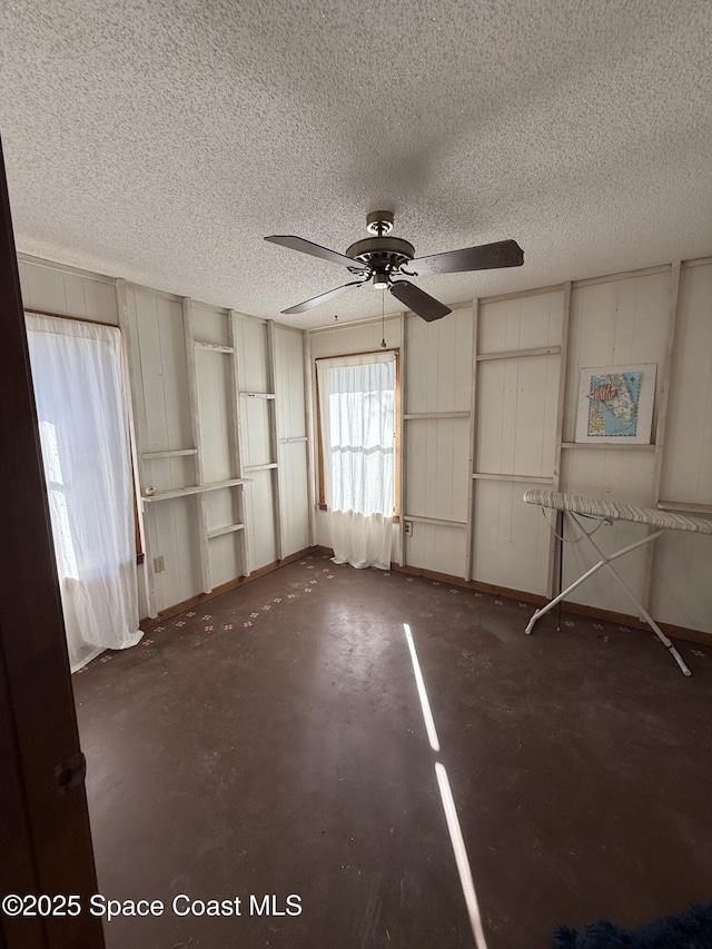 interior space featuring a textured ceiling and ceiling fan