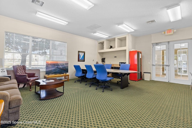 home office with carpet, a textured ceiling, and french doors