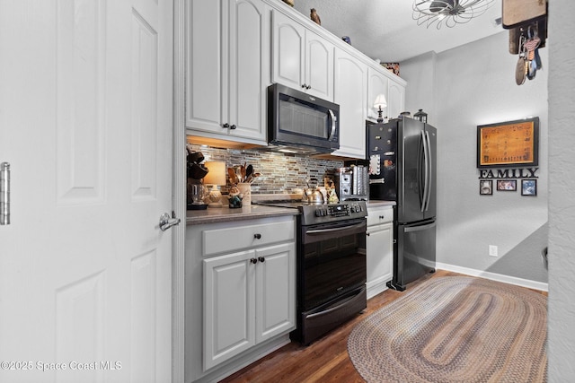 kitchen with range with electric cooktop, dark hardwood / wood-style floors, refrigerator, white cabinets, and decorative backsplash