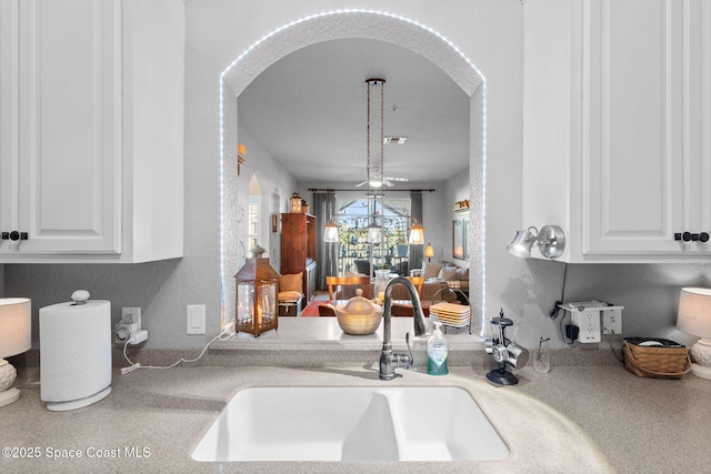 kitchen featuring white cabinetry and sink