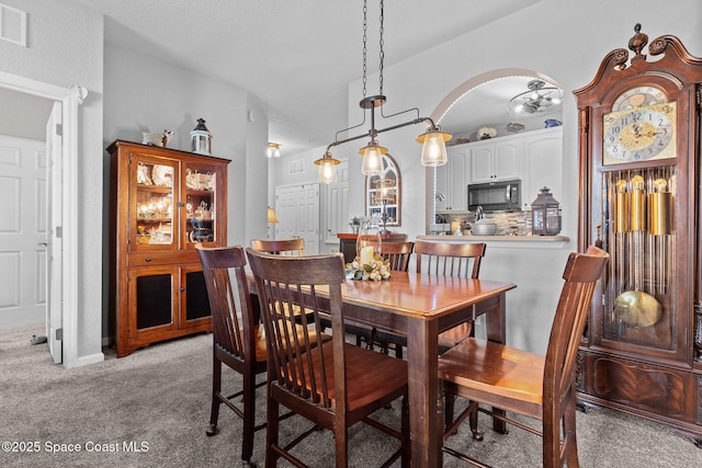 dining space featuring light colored carpet