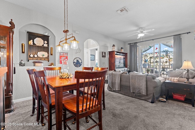 dining area featuring ceiling fan and carpet