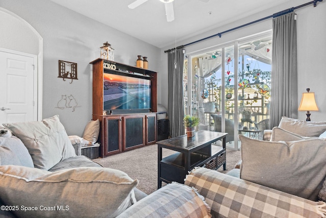 living room with ceiling fan and carpet floors