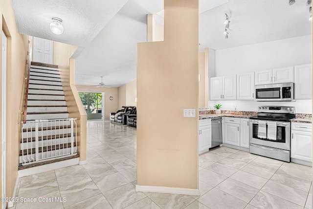 kitchen featuring white cabinets, a textured ceiling, stainless steel appliances, and ceiling fan