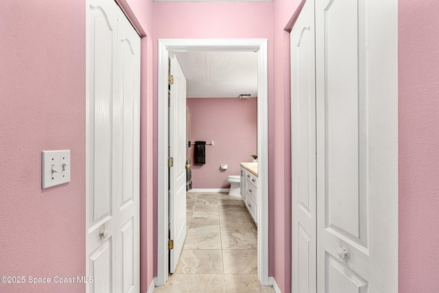 hallway featuring a textured ceiling