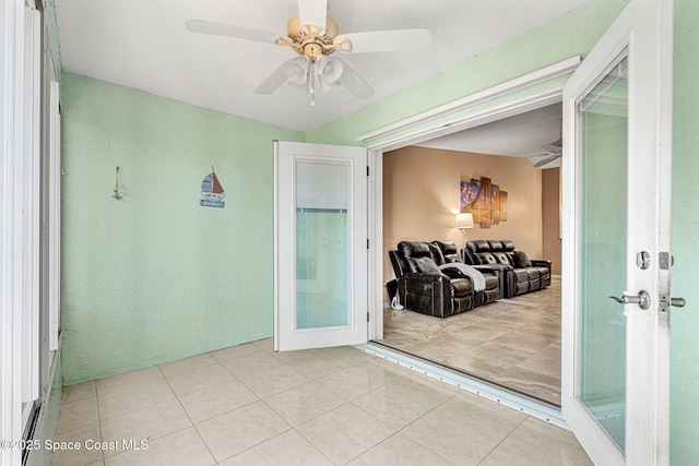 interior space featuring ceiling fan, french doors, and light tile patterned floors