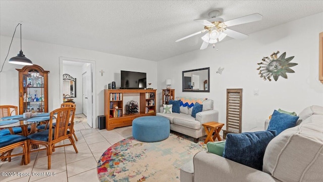 tiled living room featuring a textured ceiling and ceiling fan