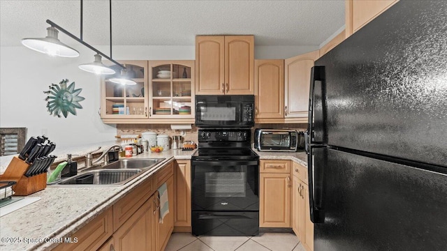 kitchen with light tile patterned floors, hanging light fixtures, a textured ceiling, black appliances, and sink