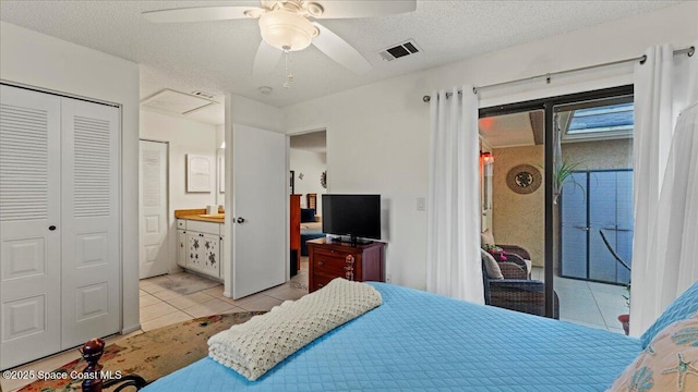 bedroom with ceiling fan, access to outside, a closet, light tile patterned flooring, and a textured ceiling