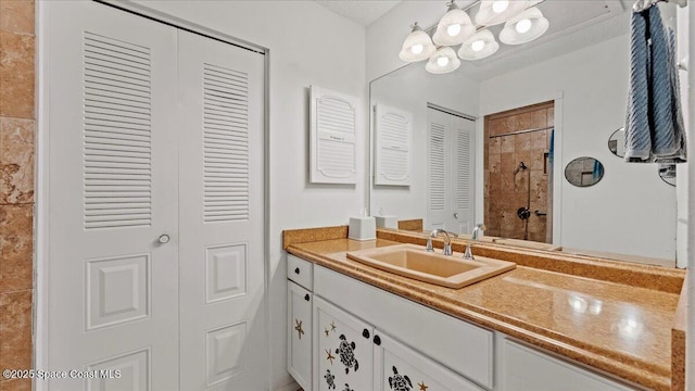 bathroom featuring walk in shower, a chandelier, and vanity