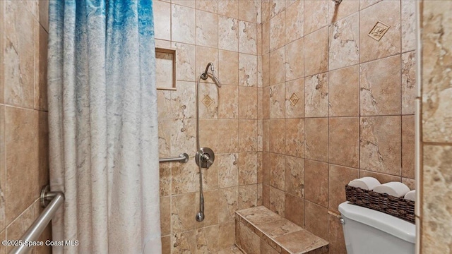 bathroom featuring toilet and walk in shower