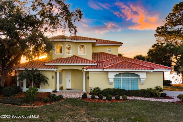 mediterranean / spanish-style home with a yard