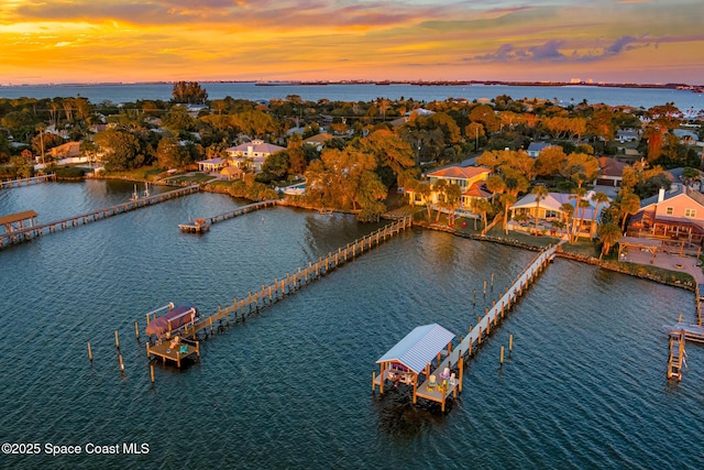 aerial view at dusk with a water view