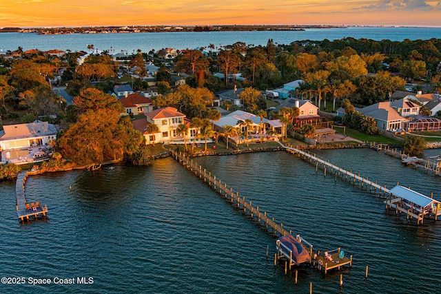 aerial view at dusk with a water view