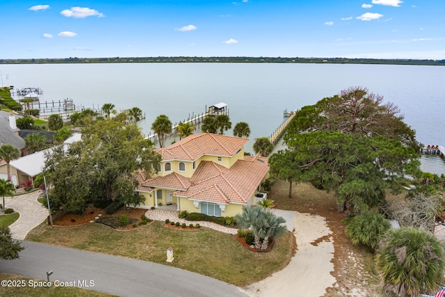 birds eye view of property with a water view