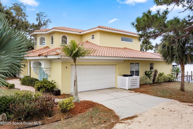 mediterranean / spanish home featuring a garage