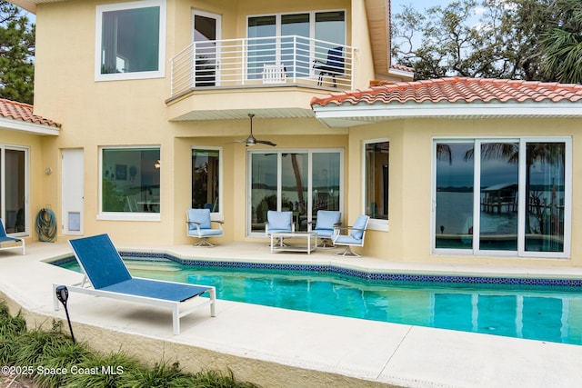 back of property featuring a balcony, ceiling fan, and a patio area