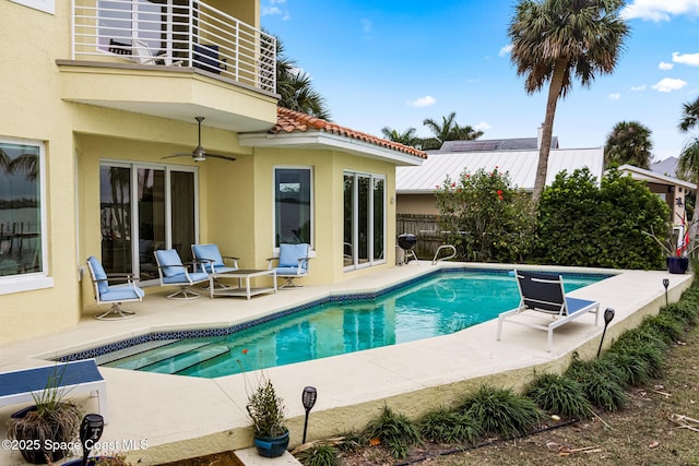 view of pool with a patio area and ceiling fan