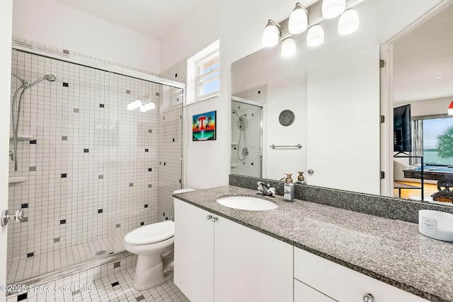 bathroom featuring tile patterned floors, walk in shower, vanity, and toilet