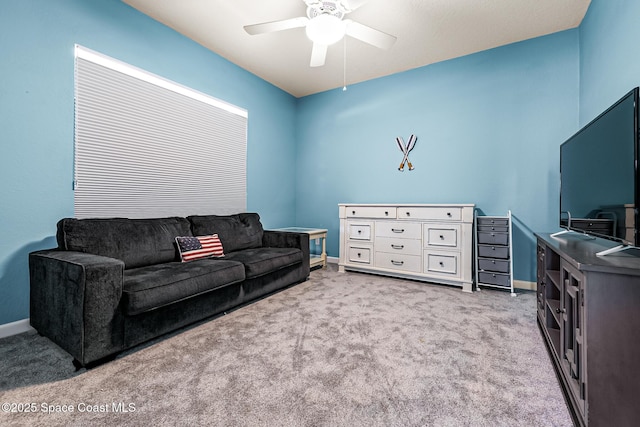 carpeted living room with ceiling fan