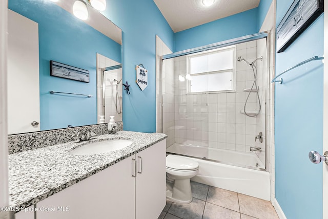 full bathroom with vanity, combined bath / shower with glass door, tile patterned flooring, toilet, and a textured ceiling