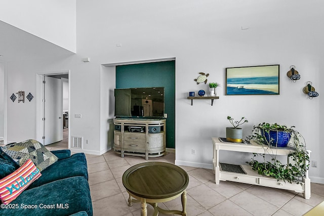 living room featuring tile patterned floors and a towering ceiling