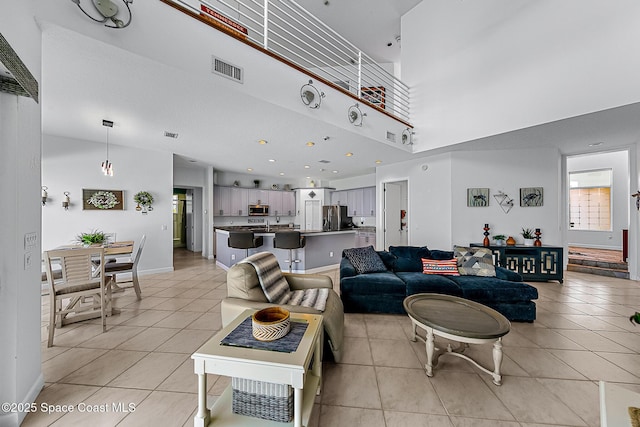 living room featuring light tile patterned flooring and a high ceiling