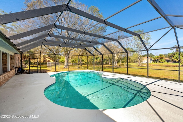 view of pool with a yard, a lanai, and a patio