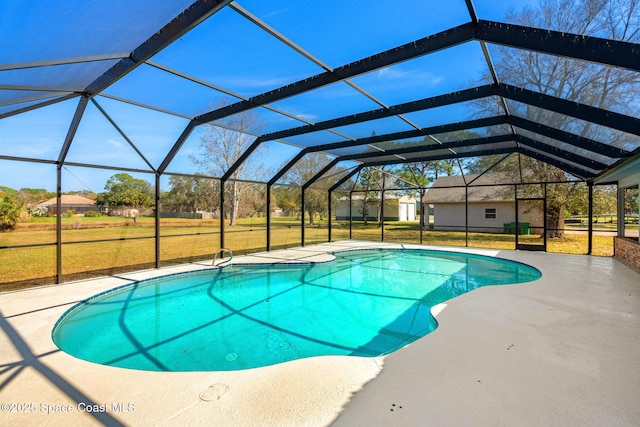 view of pool featuring a yard, a patio area, and glass enclosure