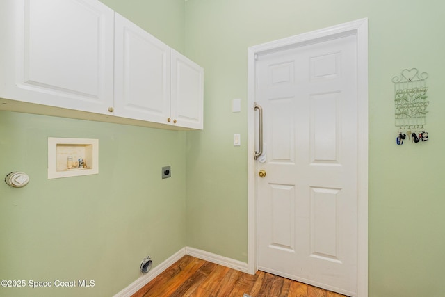 clothes washing area featuring cabinets, hookup for a washing machine, wood-type flooring, and hookup for an electric dryer