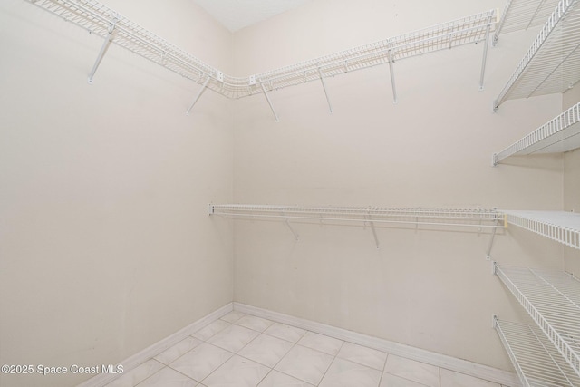 walk in closet featuring light tile patterned floors