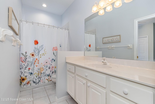 bathroom with vanity, toilet, and tile patterned flooring