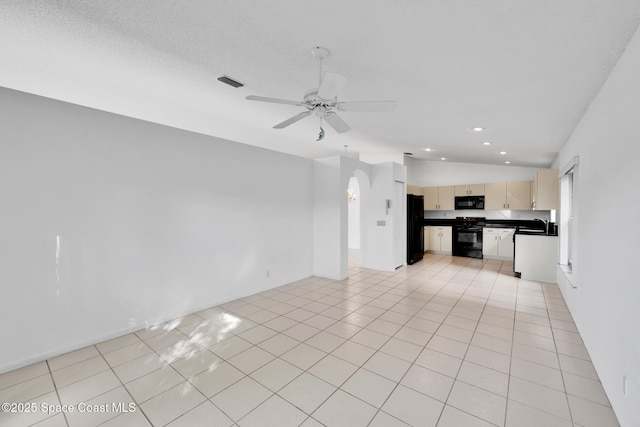 unfurnished living room featuring light tile patterned floors, vaulted ceiling, ceiling fan, and sink