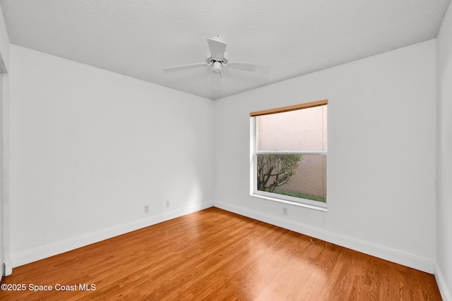 unfurnished room featuring a textured ceiling, hardwood / wood-style flooring, and ceiling fan