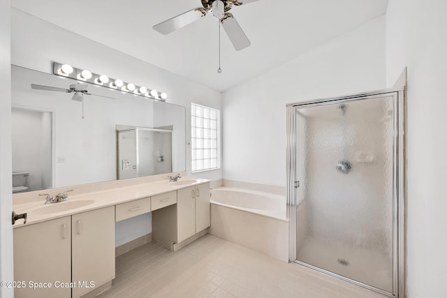 full bathroom with vanity, vaulted ceiling, ceiling fan, separate shower and tub, and toilet