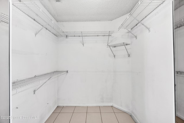 walk in closet featuring light tile patterned floors