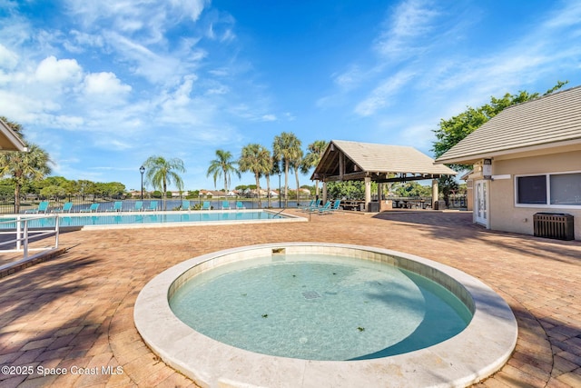 view of swimming pool featuring a gazebo and a patio