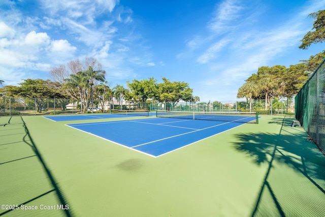 view of tennis court featuring basketball hoop