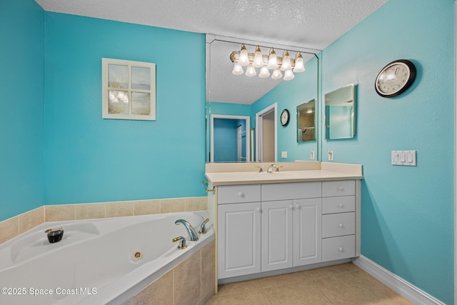 bathroom featuring a textured ceiling, tiled tub, tile patterned floors, and vanity