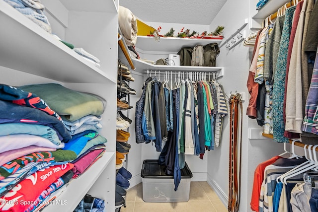 spacious closet with light tile patterned floors