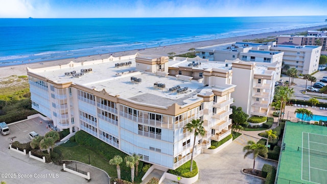 birds eye view of property with a beach view and a water view