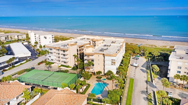 birds eye view of property featuring a beach view and a water view