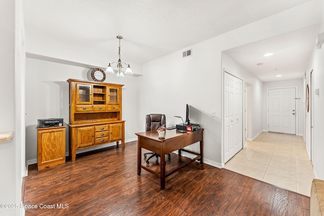 home office featuring a chandelier and light hardwood / wood-style flooring