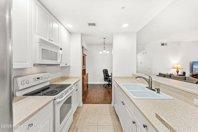 kitchen with sink, white cabinetry, light tile patterned floors, pendant lighting, and white appliances