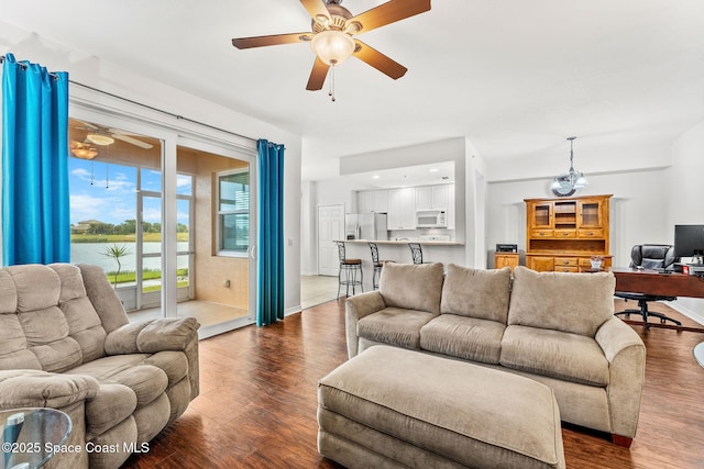 living room featuring dark hardwood / wood-style floors and ceiling fan