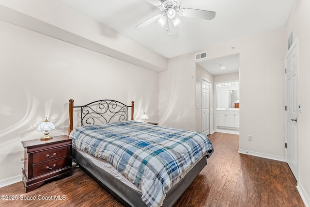 bedroom featuring ceiling fan, ensuite bathroom, and dark hardwood / wood-style floors