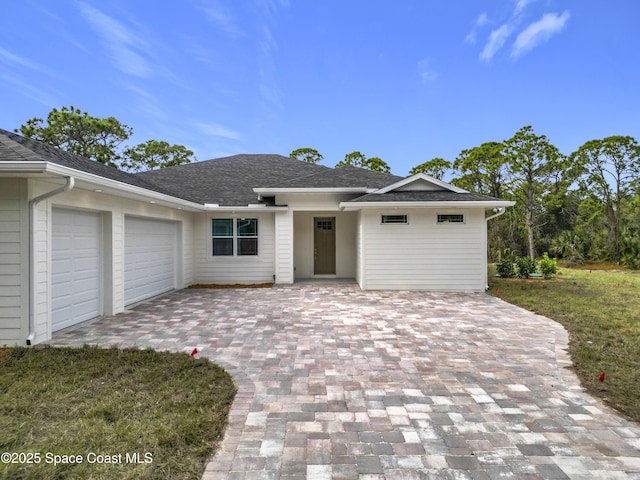 view of front of property with a front yard and a garage