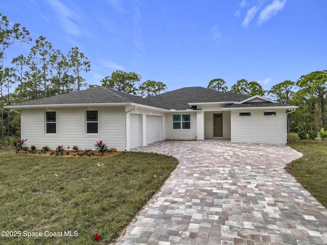 single story home featuring a front yard and a garage