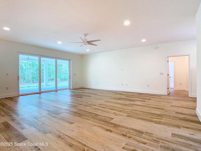 spare room featuring ceiling fan and light hardwood / wood-style flooring